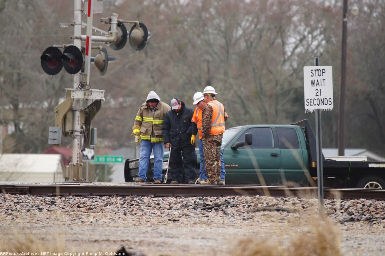 Track supervisor, track inspector and a couple of the VFD prying a crossing panel to clear the flangeway